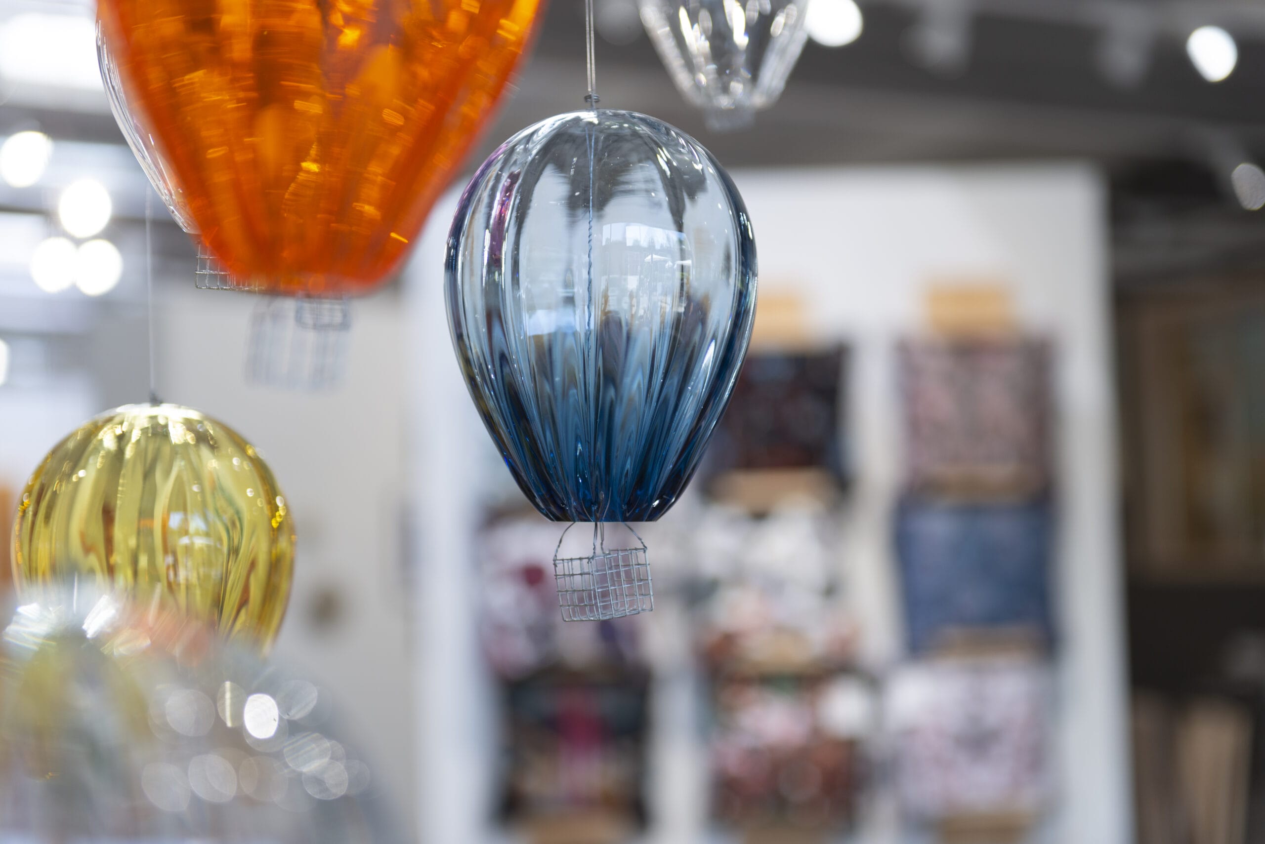 Värikkäät lasikoristeet roikkuvat ilmassa.