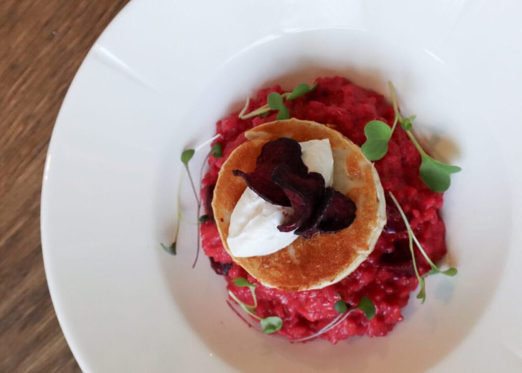 Punajuuririsotto ja pieni piirakka lautasella